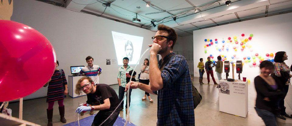 A person in a art gallery speaking into a microphone.