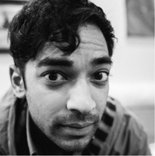 A black and white closeup of a man with dark hair