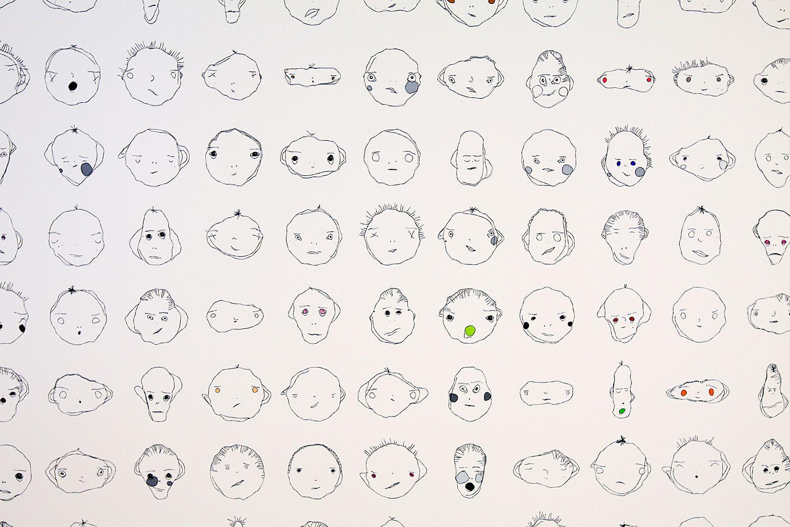 There are a variety of equally spaced apart weird faces. All of them have two eyes, two eyebrows, and a mouth. Some have hair, a nose, ears, or blush. All have unique expressions and are line drawn in black. Almost none have color.